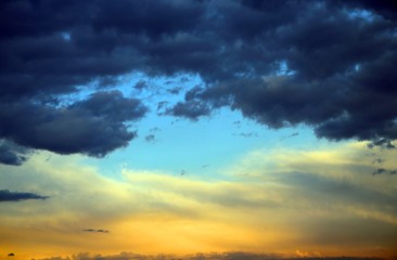 Fototapeta na wymiar Blue light filters between the orange clouds