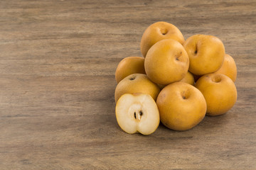 Some asian pears over a wooden surface