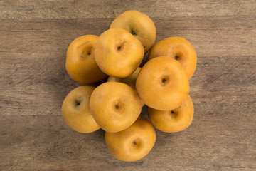 Some asian pears over a wooden surface
