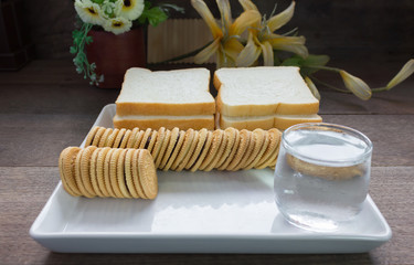 cookies with bread background  in white tray on wood table 