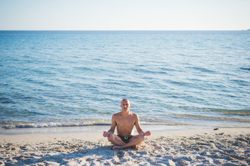 young handsome sporty man making yoga