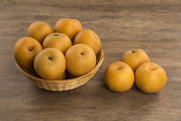Some asian pears over a wooden surface