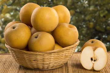 Some asian pears over a wooden surface