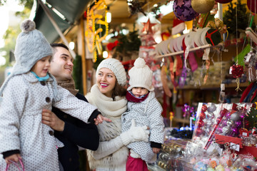 Fototapeta na wymiar Happy family of four at Christmas market