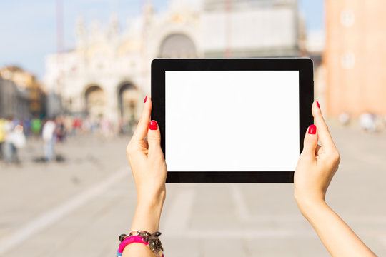 Tourist holding tablet computer with blank white screen