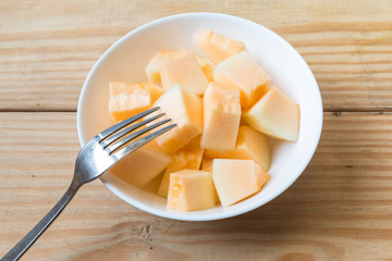 Cantaloupe in white dish with fork 2