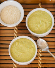 A bowl of thick, fresh, pea soup. close up