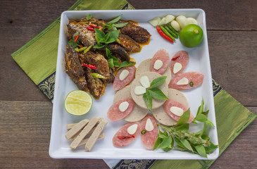 fusion menu fried fish and chilli sauce decorated with Vietnamese ham and sliced fermented pork sausage