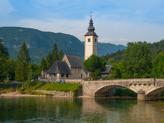 Church tower and stone bridge at Lake Bohinj