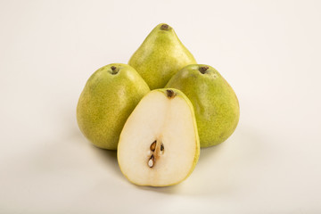 Some pears in a basket over a wooden surface seen from above