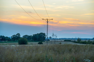 telephone pole in the field with transmission lines