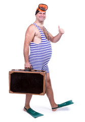 Man in swim dress walking with suitcase