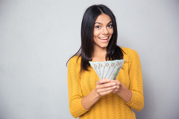 Cheerful woman holding dollar bills