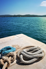 Fototapeta premium Old iron mooring mast and ropes
