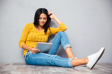 Girl sitting on the floor with tablet computer