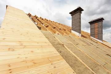 Fototapeta premium Chimneys on a wooden roof under construction