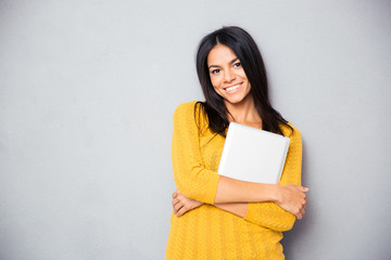 Fototapeta premium Smiling woman standing with laptop