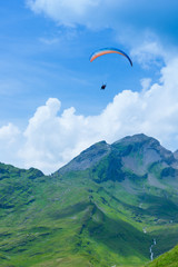 parasailing over the mountains among the clouds