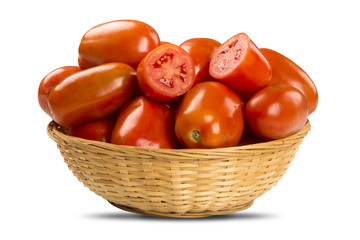 Some tomatoes over a wooden surface on a tomato field as backgro
