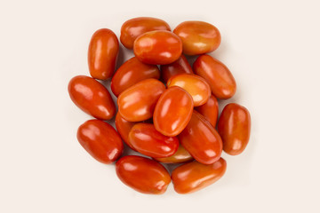 Some tomatoes over a wooden surface on a tomato field as backgro