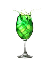 Green water spread in a wine glass isolated on white.