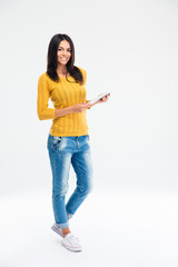 Happy woman standing and holding tablet computer © Drobot Dean