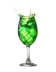 Green water spread in a wine glass isolated on white.