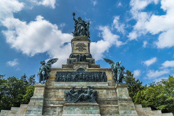 Fototapeta na wymiar Germania auf Niederwalddenkmal unter weiß-blauem Himmel