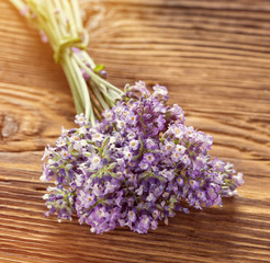 Wellness treatments with lavender flowers on wooden table. Spa still-life.