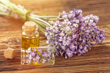 Fototapeta na wymiar Wellness treatments with lavender flowers on wooden table. Spa still-life.