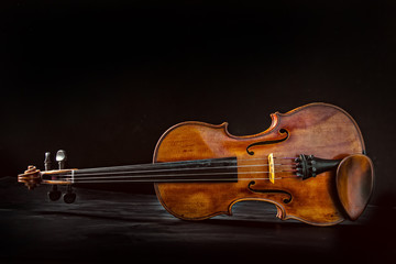 Old violin on dark background. © Lukas Gojda