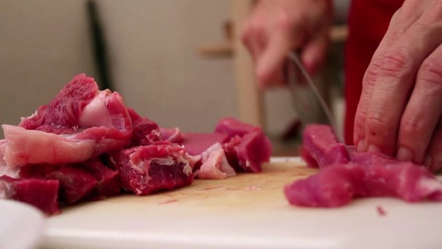 Butcher chopping beef steak 