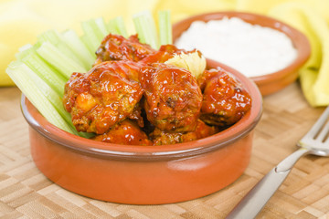 Buffalo Wings - Hot and spicy buffalo chicken wings with celery and cheese dip.
