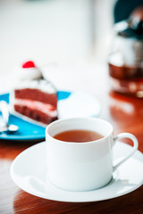 portrait image of cup of tea and cake
