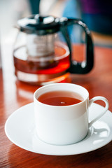 portrait image of cup of tea and cake