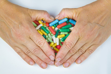 Hands holding a lot of pills