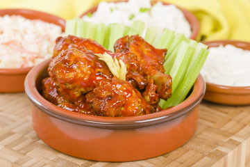 Buffalo Wings - Hot and spicy buffalo chicken wings with celery and cheese dip.
