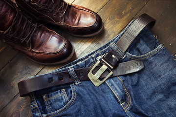 Fototapeta na wymiar Jeans belt and shoed set on wood