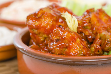 Buffalo Wings - Hot and spicy buffalo chicken wings with celery and cheese dip.
