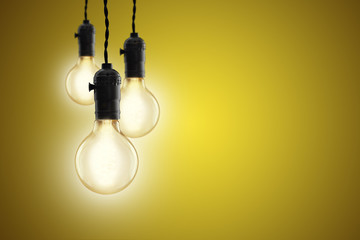 Idea concept - Vintage incandescent bulbs on yellow background