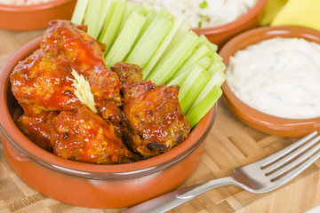 Buffalo Wings - Hot and spicy buffalo chicken wings with celery and cheese dip.
