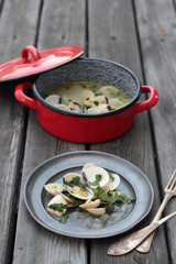 White clamshells with wine and parsley sauce.