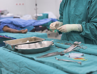 scrub nurse preparing medical instruments for operation