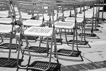 Naklejka premium Rows of empty white metal chairs