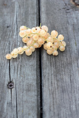 Bunch of white currant berries on timber planks.