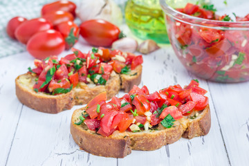 Bruschetta with tomatoes, herbs and oil on toasted garlic cheese bread
