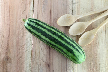 cucumber and wooden spoon.