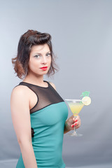 pretty brunette young girl taking a fruit cocktail