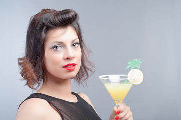 pretty brunette young girl taking a fruit cocktail