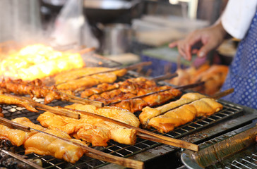 Man cooking chicken on barbecue